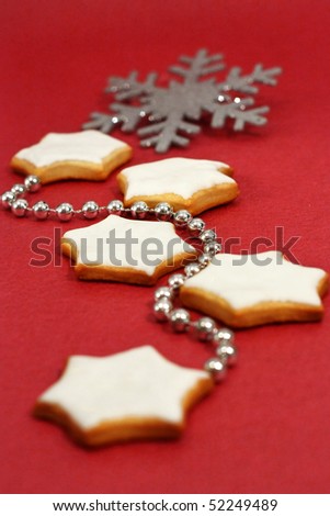 Christmas star cookies with white royal frosting and sparkling decorations