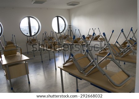 A empty classroom with the chairs grouped on the desks  for the end of the school and the start of the summer holidays