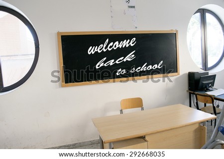 A blackboard in the classroom at school with the message welcome back to school written with white chalk on it symbolizing the end of the holidays and the start of the new year