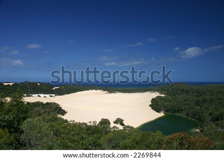 Dune in the middle of the rain forest, with a small green lake (Fraser Island, Australia)