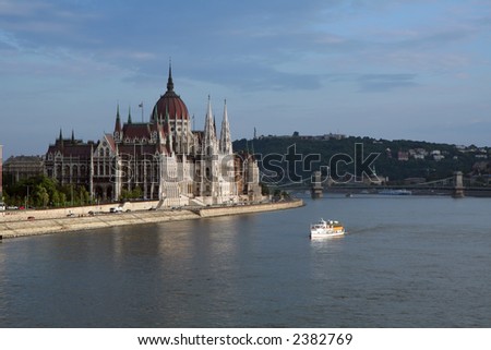 Boat cruising in front of the Parliament House (Budapest, Hungary)