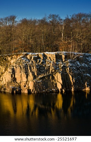 Rocky shore of a small lake in winter setting (Sweden)