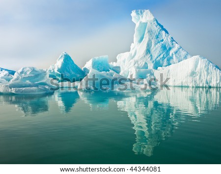 Icebergs floating in calm water.  Horizontally framed shot.