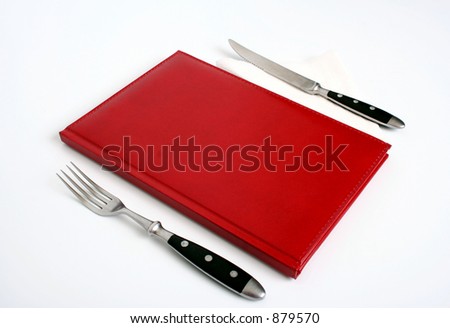 book, fork and knife isolated on white