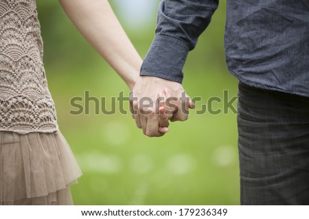 couple holding hands close up