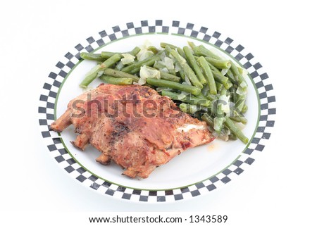 baked ribs with green beans on a plate