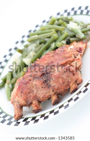baked ribs with green beans on a plate