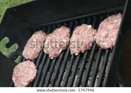raw hamburger on a barbeque