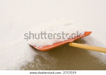 shoveling snow with a shovel after a snowfall