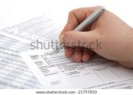 filling income tax form with pen isolated against white background