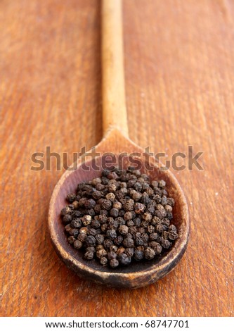 black pepper on a wooden table.Spices closeup