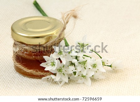 Honey with flower  on linen tablecloths