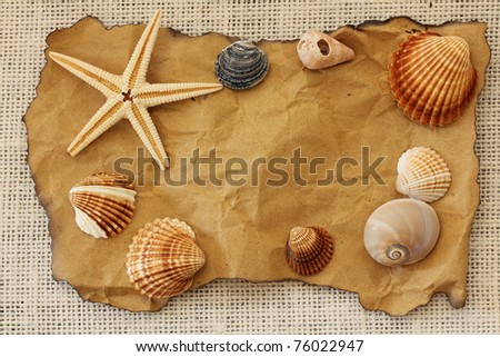 Old paper tag on natural burlap with seashell