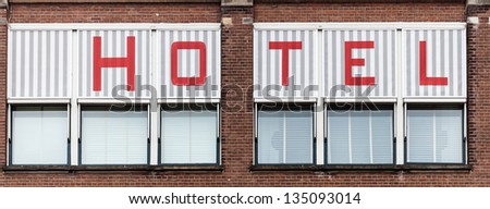 Sign HOTEL drawn above the windows on a wall