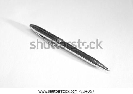Metal ballpoint pen on a white background; focused on pen tip
