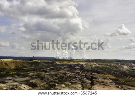 Open-pit mining for lignite (brown coal) that is burnt and transformed to electricity by the power station at the horizon - largest mining sites and power production site in Germany