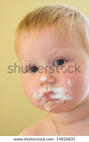 toddler boy with his face dirty in ice cream