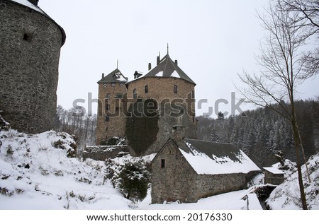 Castle in Ardennes (Belgium) in the winter; ground covered by white blanket of snow.