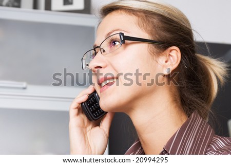 Happy young business woman having phone conversation