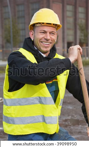 Laughing construction worker in yellow hard hat