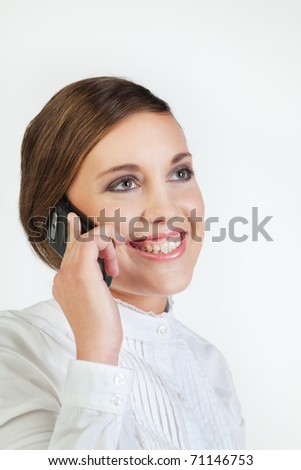 Head portrait of young smiling businesswoman talking on cellphone