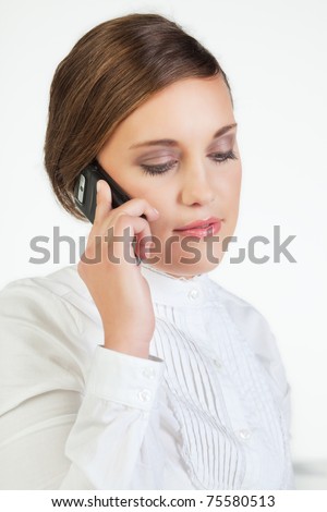 Head portrait of young smiling businesswoman talking on cellphone