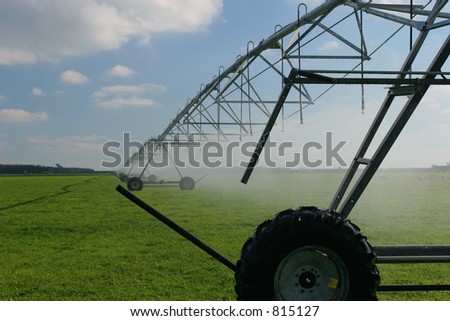 Large center pivot irrigation system running on an open plains dairy farm in Canterbury, New Zealand.