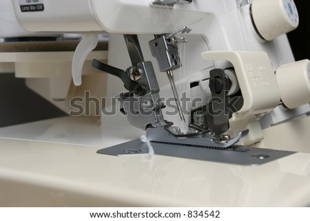 Looking at the needle, cutting blade and foot on a overlocker.