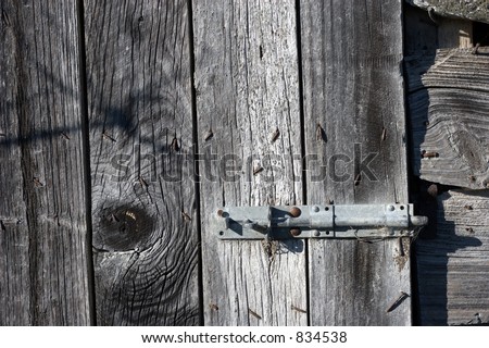 Detail shot of a hasp and stable lock on an old decrepit farm out building.  Continuing my old buildings theme.