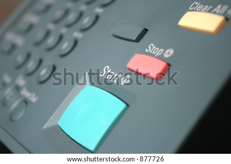 Green Start Button on a photo copier/fax/printer.  Shallow focus, on work start.