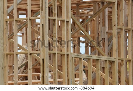 View of a partially built timber framed house.  Complex lines and angles.
