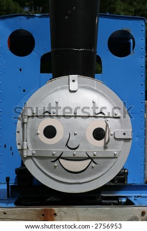 Face painted on old steam engine in a children\'s park