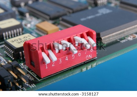 Macro of DIP switch and circuit board edge, check the settings, on blue background