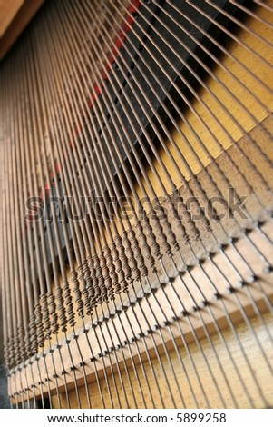 The strings in the lower half of an upright piano.