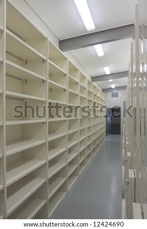 Brand new records storage room, beige metal shelves with lots of space.