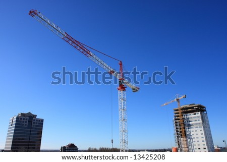 Two large construction cranes operating in Christchurch city, New Zealand.
