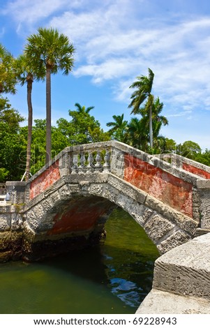 Venetian style bridge and palm trees at Vizcaya Museum & Garden in Miami, Florida