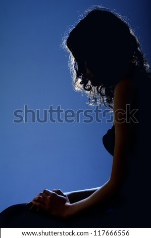 silhouette profile of woman sitting in moonlight