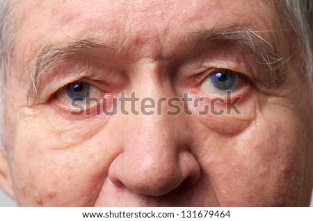 old man face part closeup eyes looks at camera