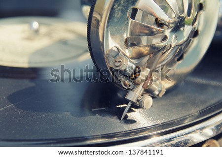 elder retro gramophone head with needle on scratched disc