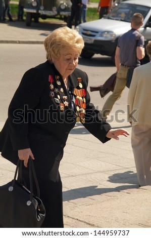 KALININGRAD, RUSSIA - MAY 07:  senior woman veteran of the World War II with her medals walked at street on during the victory celebration in World War II on May 07, 2013 in Kaliningrad, Russia