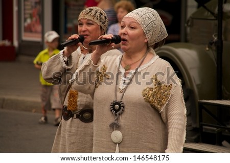 KALININGRAD, RUSSIA - JULY 14: women in russian national dress sang and danced on the street on City Day of Kaliningrad celebration on July 14, 2013 in Kaliningrad, Russia
