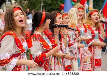 KALININGRAD, RUSSIA - JULY 14: girls in russian national dress sang and danced on the street on City Day of Kaliningrad celebration on July 14, 2013 in Kaliningrad, Russia