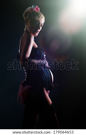 sad pregnant woman in black lingerie