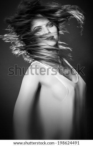 Young Woman\'s Long Hair Flying in Motion Blur effect monochrome image
