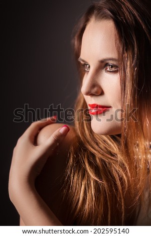 woman with red fluffy hair embraced herself