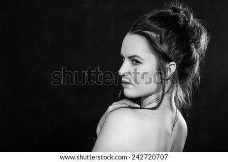 sad topless girl looking over shoulder, monochrome image