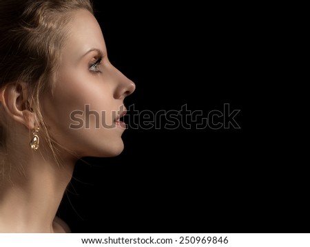 sad pensive female profile on black background