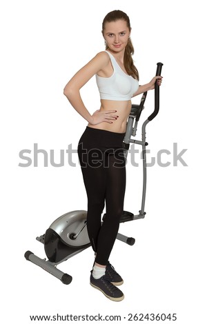 slim woman posing near home elliptical trainer isolated