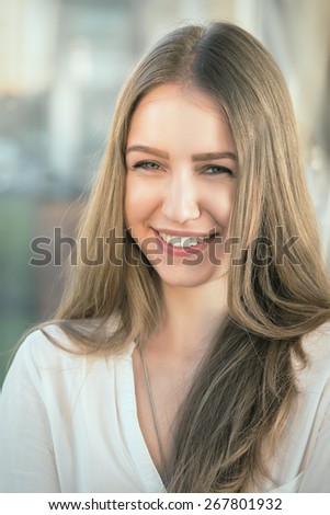 pretty smiling woman with long hair toned image